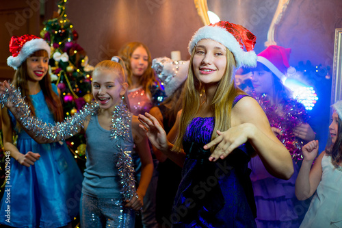 Group of young girls celebrating Christmas. First plan