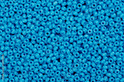 Multicolored blue glass seed beads background.