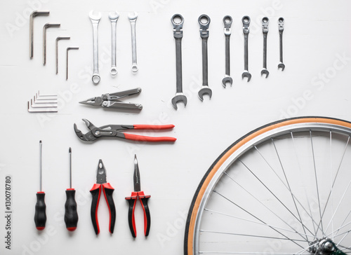 Bicycle fixing tool kit. Flat lay of work tools and bicycle wheel
