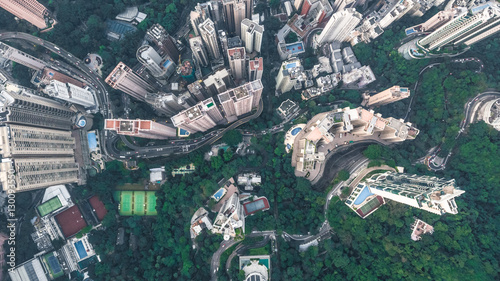 Top view or aerial shot of skyscrapers and green trees in a big city. Hong Kong, China.