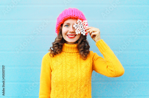 Fashion happy smiling young woman wearing colorful knitted hat s