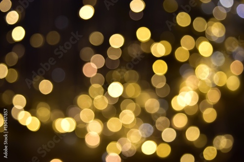 Glittering bokeh circular gold on black background .
