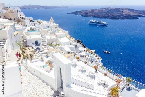 Beautiful panoramic view on the mediterranean sea, caldera and volcano. Traditional white architecture of Santorini island, Thira, Greece. Cruise ship in blue sea. 