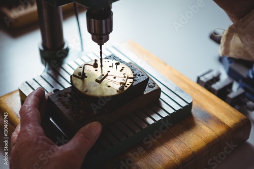 Horologist repairing a watch