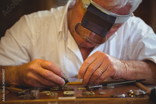 Horologist repairing a watch