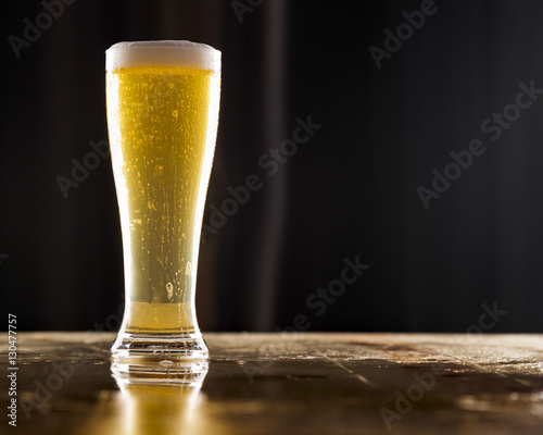 Tall glass of pilsner beer