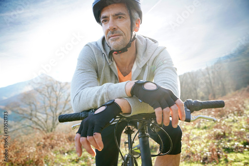 Mature man riding bike in the mountain