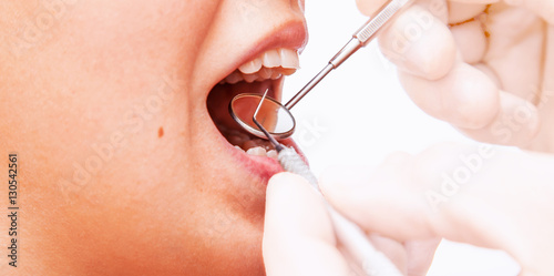 Doctor doing dental treatment to his patient in clinic.