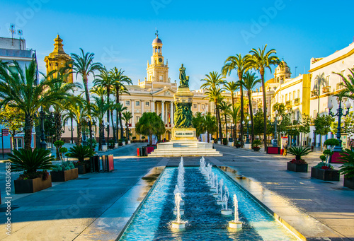 View of a fountain situated on the square of saint john of god in cadiz with town hall on background