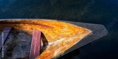 Dugout Native American canoe floating in water. Top view close up detail. Copy space.