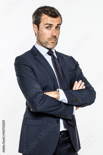 snob middle aged businessman with arms crossed standing with arrogance