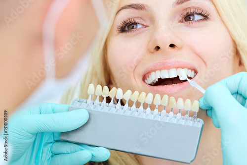 Closeup of a girl with beautiful smile at the dentist. Dental care concept. Whitening