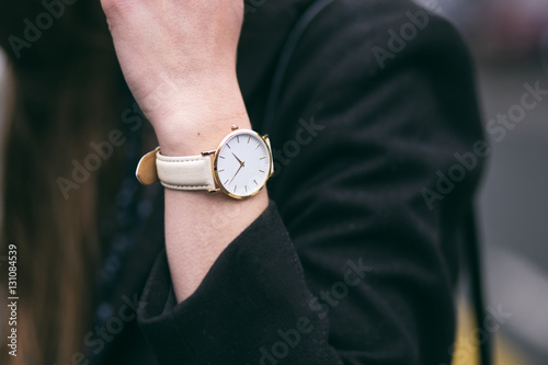 young business woman wearing golden and white watch. close up fashion details. ideal fall outfit accessories.