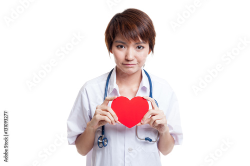 Asian young female doctor hold a red heart.