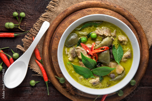 Thai food chicken green curry on dark wooden background. top view