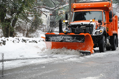 snowplow removing snow in the street after blizzard