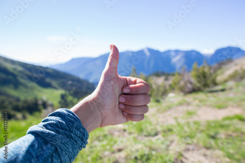 Hiker showing thumbs up for view in background, Enchantments, Alpine Lakes Wilderness, Washington, USA