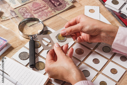 Woman looks at the collector s coin