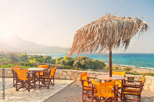 cafe balcony with tables at sunrise overlooking sea