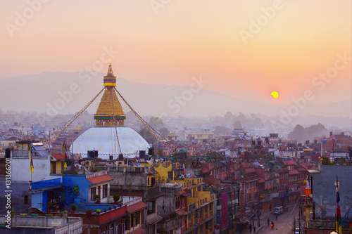 Kathmandu city view on the early morning on sunrise with rising sun and famous buddhist Boudhanath Stupa temple. Tibetan traditional architecture, Nepal.