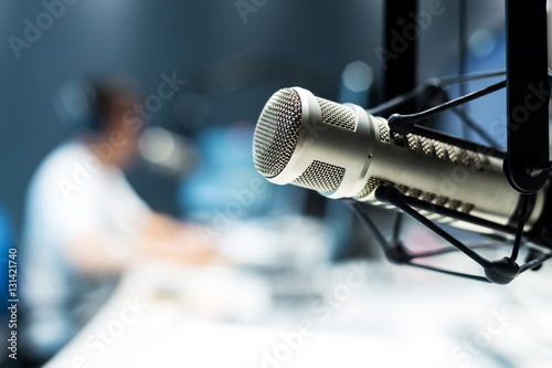 young man dj works in modern broadcast studio