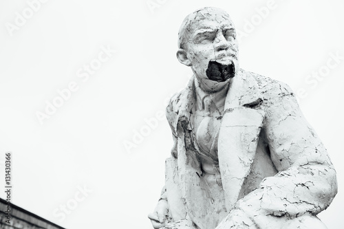 Damaged Lenin statue, peeling vintage paint. The concept of syst