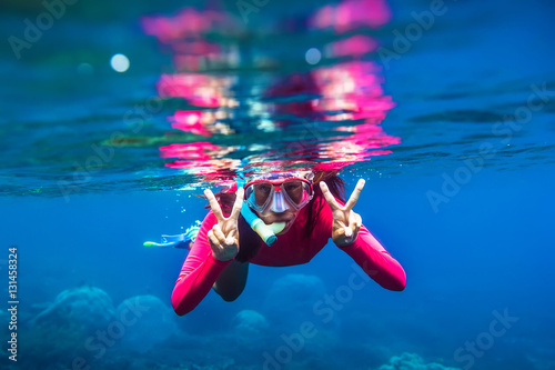 Underwater swimming in blue ocean