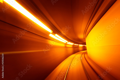 Speed motion blurred underground subway tunnel yellow color toned