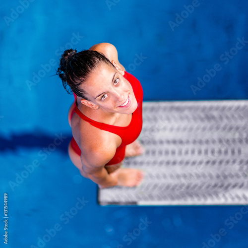 Portrait of female diver.Female diver standing on the jumping board.
