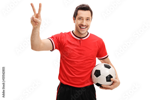 Delighted football player making a victory gesture