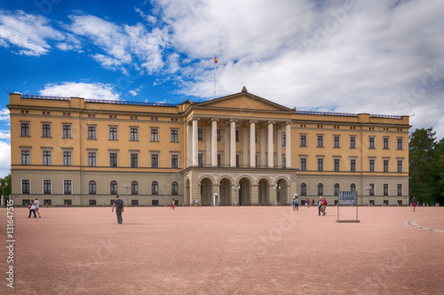 Oslo, Norway - July 18, 2016: View of the Slottet, the Royal Palace in Oslo in sunny daylight. The image is shot inside the square in front of it during a beautiful day with an huge blue sky.