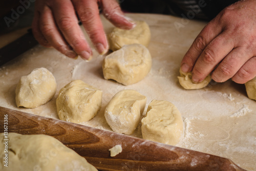 Female hands making the dough pieces