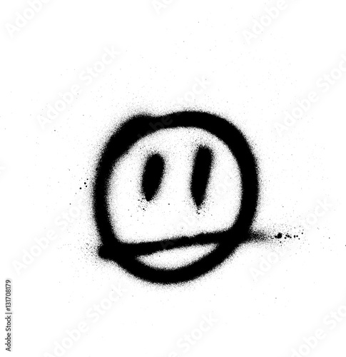 graffiti sprayed face emoticon in black on white