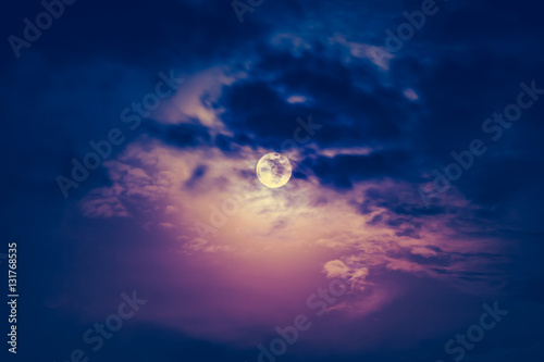 Nighttime sky with cloudy and beautiful moon. Vintage effect ton