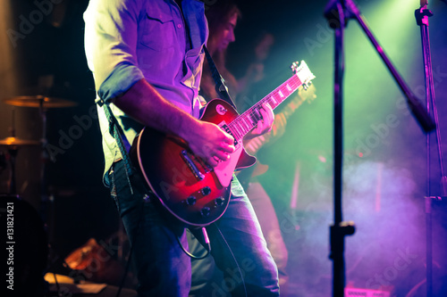guitarist playing electrical guitar on a rock concert