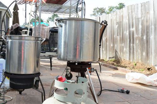 Two home brew kettles boiling wort with propane tank