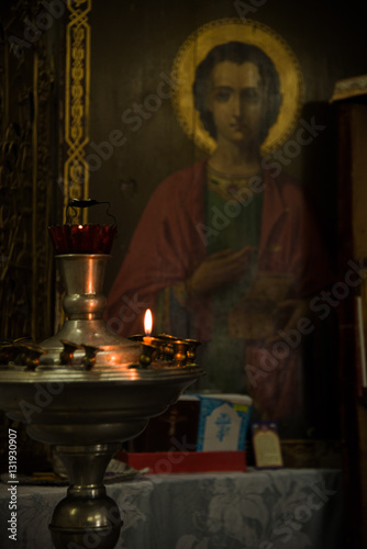 Candle at the icon of St. Panteleimon