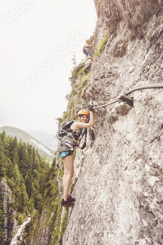 Woman climbing via ferrata in Austria