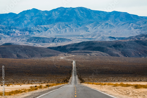 Road in the Death Valley National Park with mountains on the horizon. USA