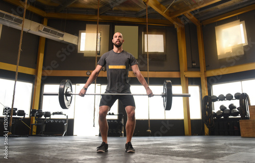Strong man doing a crossfit power lift 