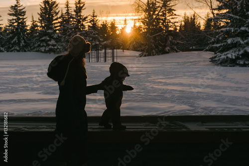 Mom and toddler in snowy Winter scene