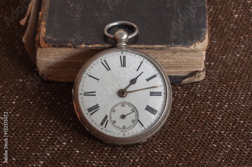 Silver pocket watch and Bible