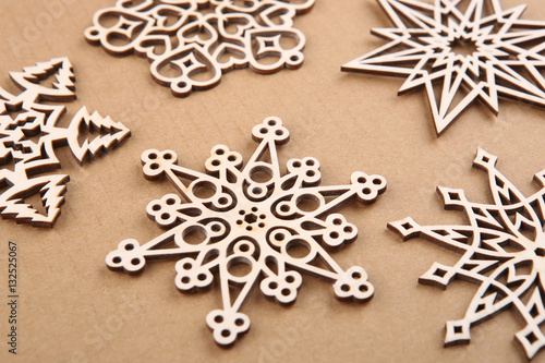 Laser cut wood snowflakes ornaments. Wooden snowflakes on carton.