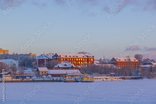 old houses in the light of dusk in winter city