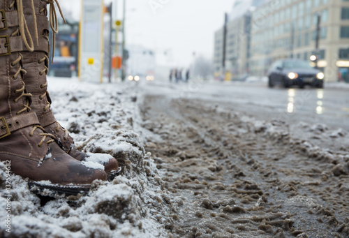 Snow mats and dirty streets in a big city