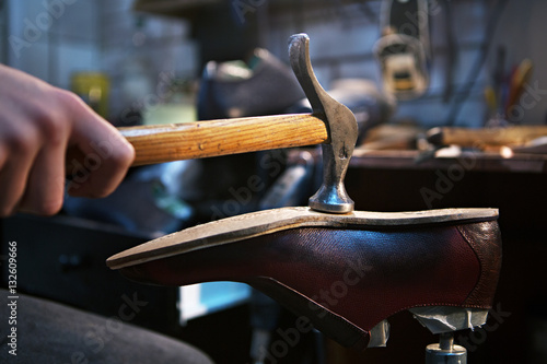 shoemaker makes and repairs shoes for men