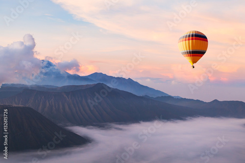 beautiful inspirational landscape with hot air balloon flying in the sky, travel destination