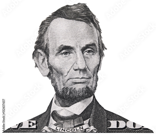US president Abraham Abe Lincoln face portrait on USA 5 dollar bill closeup isolated, United States of America money close up.