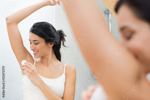 Woman using deodorant stick