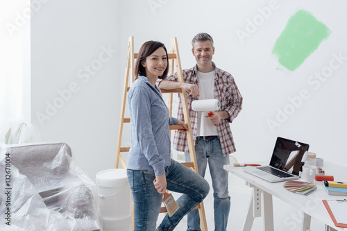 Couple painting their house